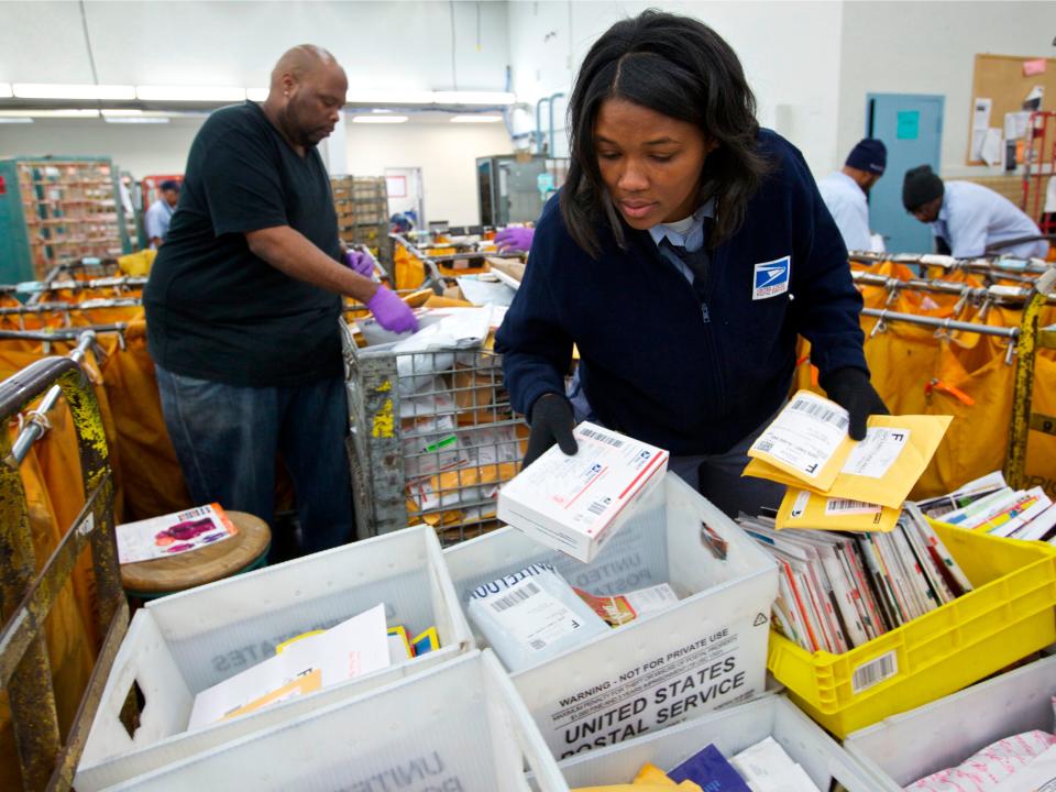 United States Postal Service clerks sort mail at the USPS