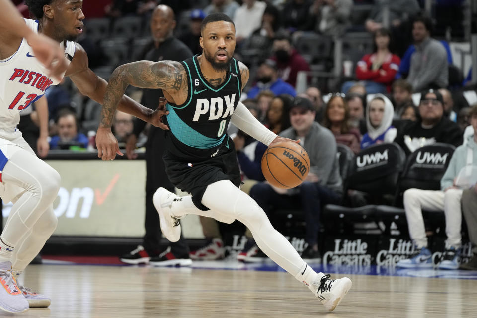 Portland Trail Blazers guard Damian Lillard brings the ball up court during the first half of an NBA basketball game against the Detroit Pistons, Monday, March 6, 2023, in Detroit. (AP Photo/Carlos Osorio)