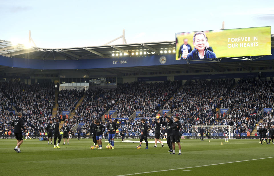 Tributes to those who lost their lives in the Leicester City helicopter crash including Leicester City Chairman Vichai Srivaddhanaprabha on the screens as Leicester City players warm up ahead of the English Premier League soccer match at the King Power Stadium, Leicester, England. Saturday Nov. 10, 2018. (Joe Giddens/PA via AP)