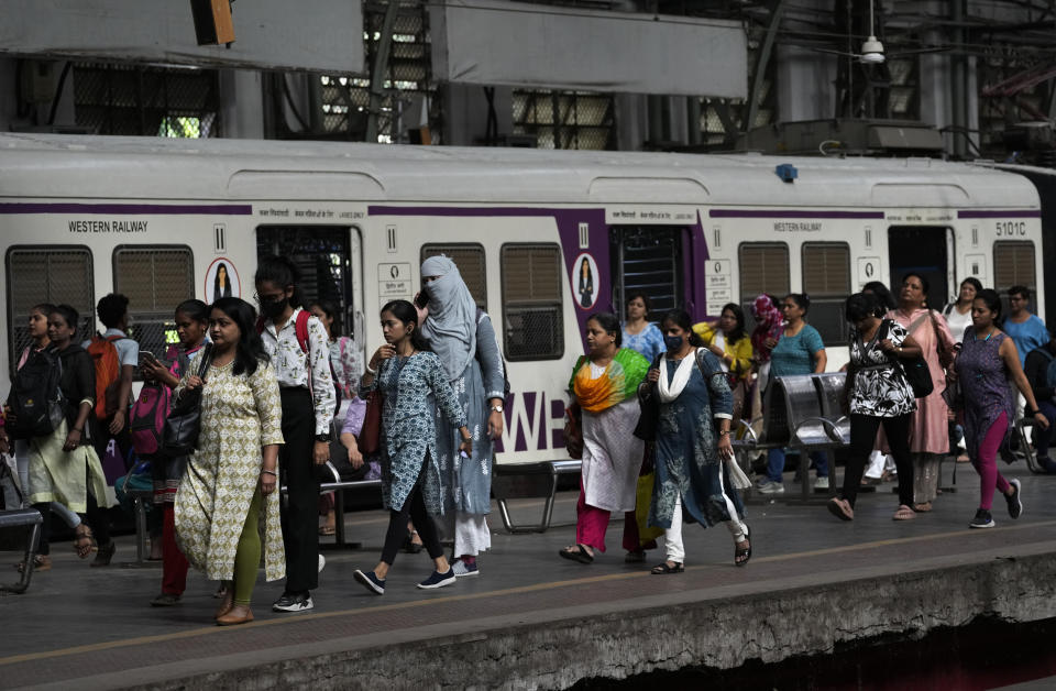 Women walk at a platform during peak hours at Churchgate station in Mumbai, India, Monday, March 20, 2023. India will soon eclipse China to become the world's most populous country, and its economy is among the fastest-growing. But the number of Indian women in the workforce, already among the 20 lowest in the world, has been shrinking for decades, a growing challenge for India’s own economic ambitions if its estimated 670 million women are left behind as its population expands. (AP Photo/Rajanish Kakade)
