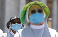 Nuns wearing protective masks attend the Angelus prayer celebrated by Pope Francis from his studio window overlooking St. Peter's Square at the Vatican, Sunday, July 5, 2020. (AP Photo/Riccardo De Luca)