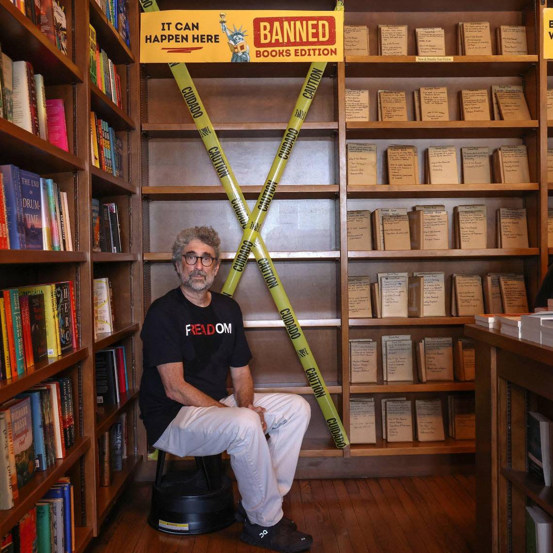 Books & Books owner Mitchell Kaplan sits near empty book shelves to illustrate the effects of Florida’s book ban during the “Walk for Freadom” kickoff event on Sunday, October 1, 2023 in Coral Gables, Florida. The march began at the Coral Gables Congregational United Church of Christ and ended at Books & Books.