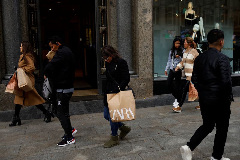 People walk past a Zara store in central Madrid