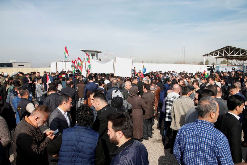 People demonstrate in front of the United Nations headquarters in Erbil