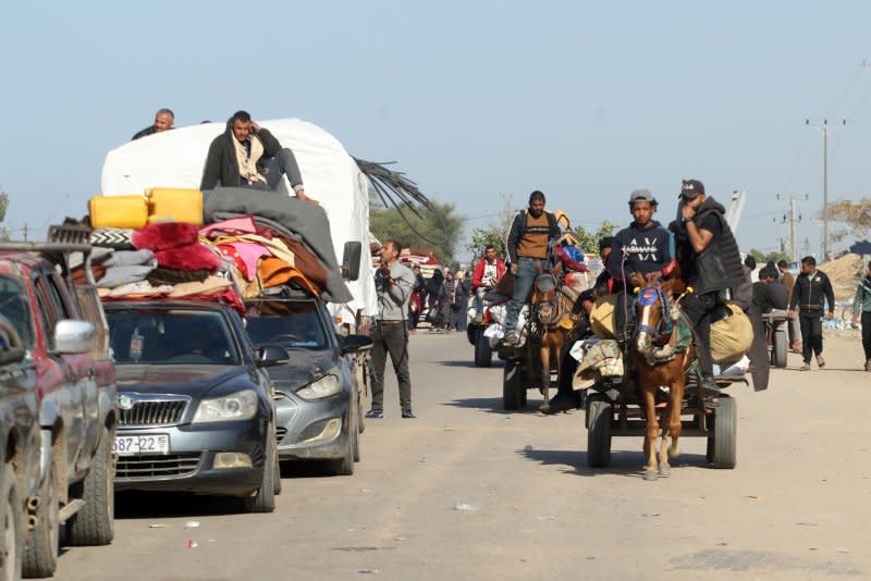 Palestinian families flee Khan Younis on the coastal road leading to Rafah in the southern Gaza Strip on Monday. Photo by Ismael Mohamad/UPI