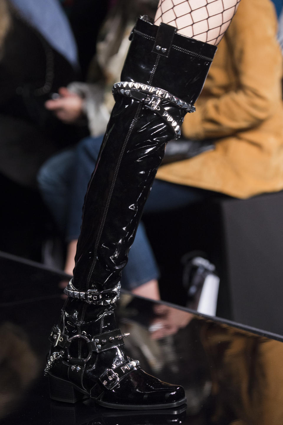 <p><i>Black patent leather studded knee boots from the SS18 Moschino collection. (Photo: ImaxTree) </i></p>