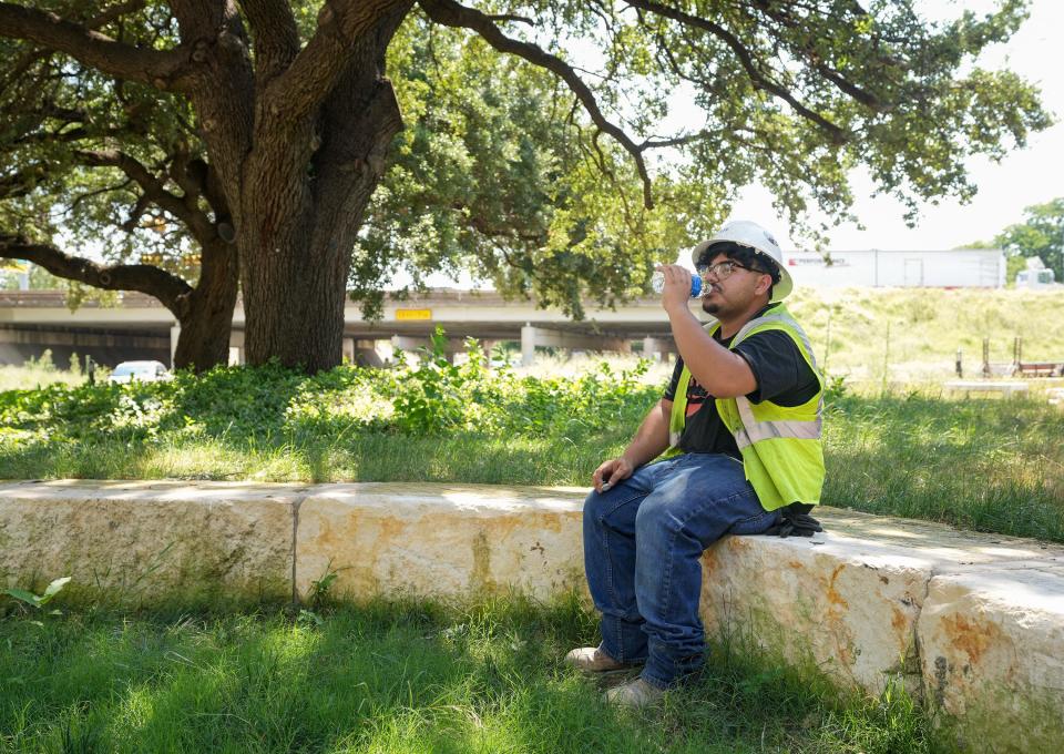 Construction worker Joseph Miller takes a break from building a condominium tower in the Rainey Street District last month. A state law that will go into effect Sept. 1 would prohibit cities from requiring such breaks.