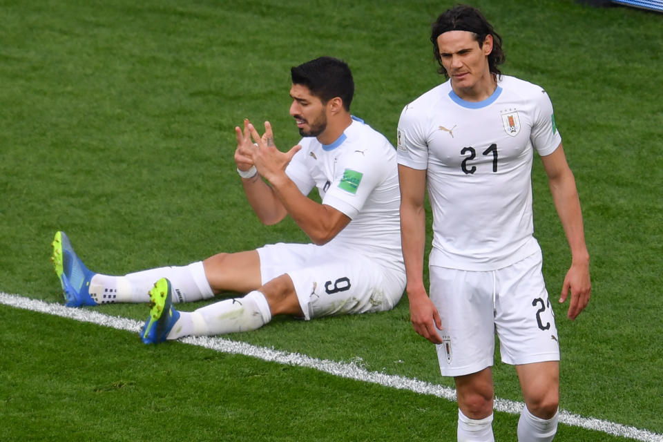 Luis Suarez sulks after missing a chance to score against Egypt while Edinson Cavani looks on (Getty).