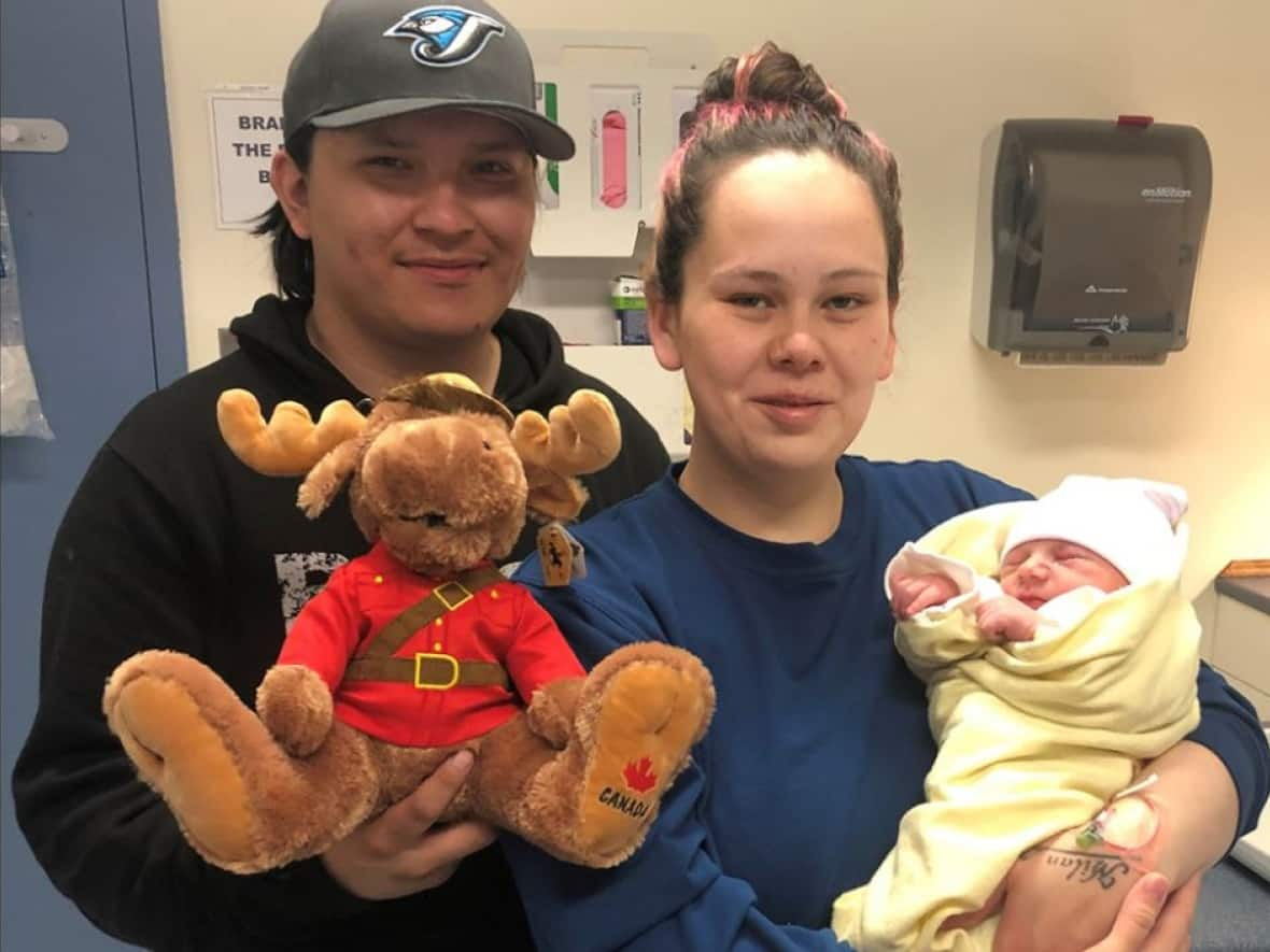 Newborn baby Dylan with his parents, Mitchell Muskego and Christian Danis. Two Norway House RCMP officers helped deliver the baby at the couple's home on Kinosao Sipi First Nation, also known as Norway House Cree Nation, in northern Manitoba on Friday, May 20, 2022. (RCMP - image credit)