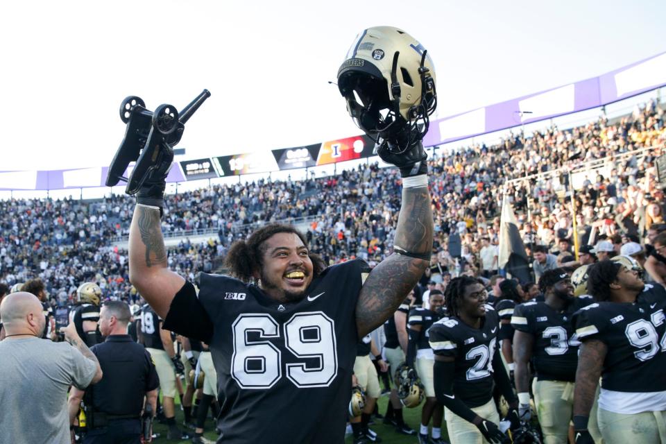 Purdue offensive lineman Greg Long (69) hoists the Cannon Trophy as Purdue celebrates defeating Illinois, 13-9, Saturday, Sept. 25, 2021 at Ross-Ade Stadium in West Lafayette, Ind.