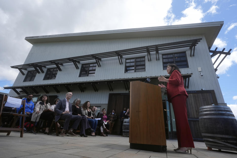 Acting United States Secretary of Labor Julie Su, right, speaks at a news conference at Balletto Vineyards in Santa Rosa, Calif., Friday, April 26, 2024. Temporary farmworkers workers are getting more legal protections against employer retaliation, unsafe working conditions, illegal recruitment and other abuses. The rule announced Friday by the Biden administration aims to bolster support workers on H-2A visas. (AP Photo/Jeff Chiu)