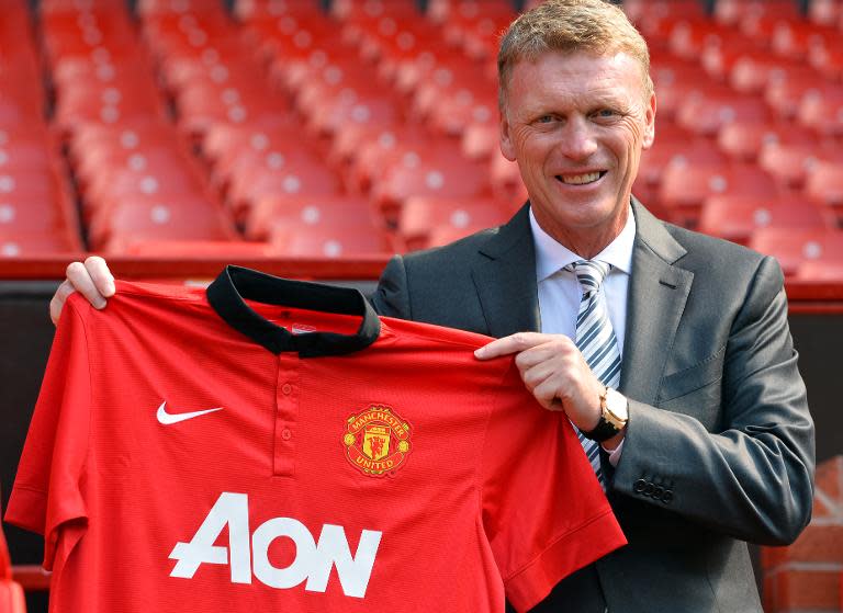 File picture taken on July 5, 2013 shows Manchester United's new Scottish manager David Moyes holding up a club shirt during a photocall at Old Trafford in Manchester, north-west England