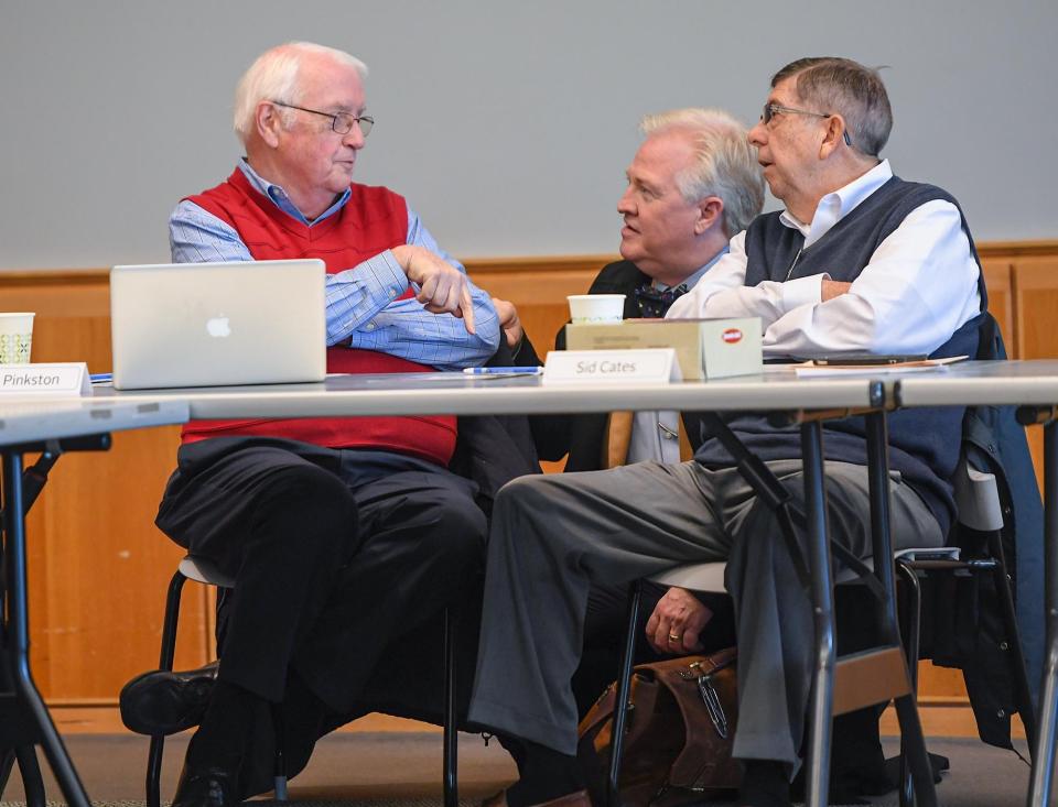 Greenville County Library System Board member Bill Pinkston, left, Chairman of the Board of Directors Alan Hill and Vice Chairman Sid Cates talks before starting their meeting at the Hughes Main Library in Greenville, S.C. Monday, December 5, 2022. 