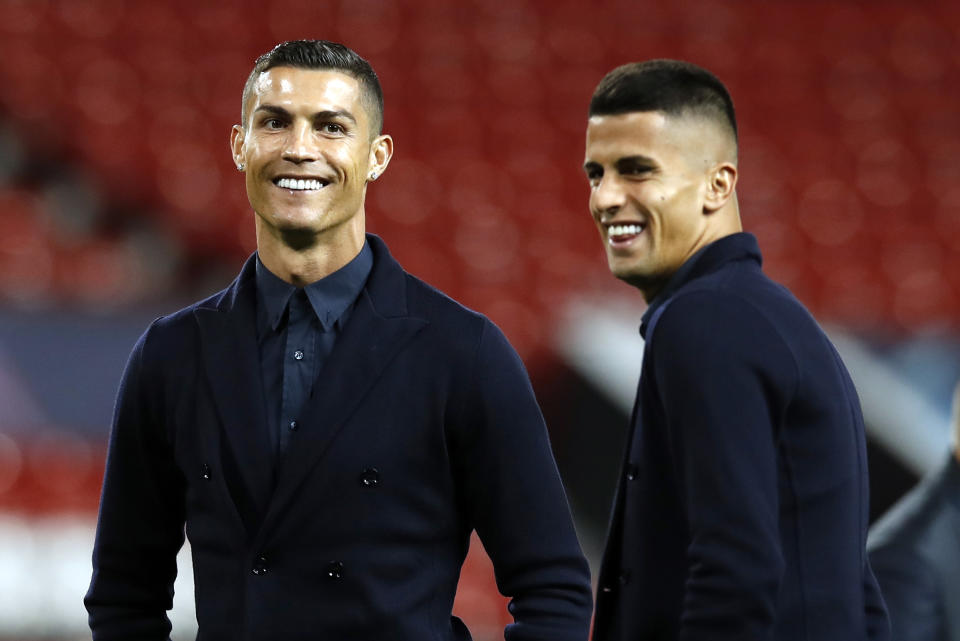 Juventus' Cristiano Ronaldo, left, during the walkaround at Old Trafford, Manchester, England, Monday, Oct. 22, 2018. Juventus will play a Champions League soccer match against Manchester United on Tuesday. (Martin Rickett/PA via AP)