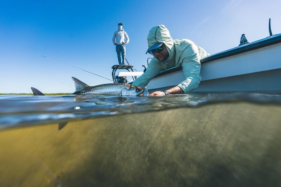 an angler tarpon fishing from a flats boat