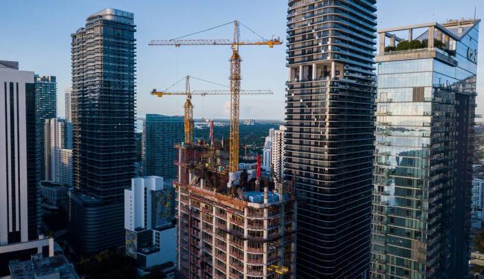 The under-construction 55-story office tower already is signing up big-name tenants. Above: Aerial view shows the construction progress of 830 Brickell, in Miami, Florida on Friday, September 24, 2021.