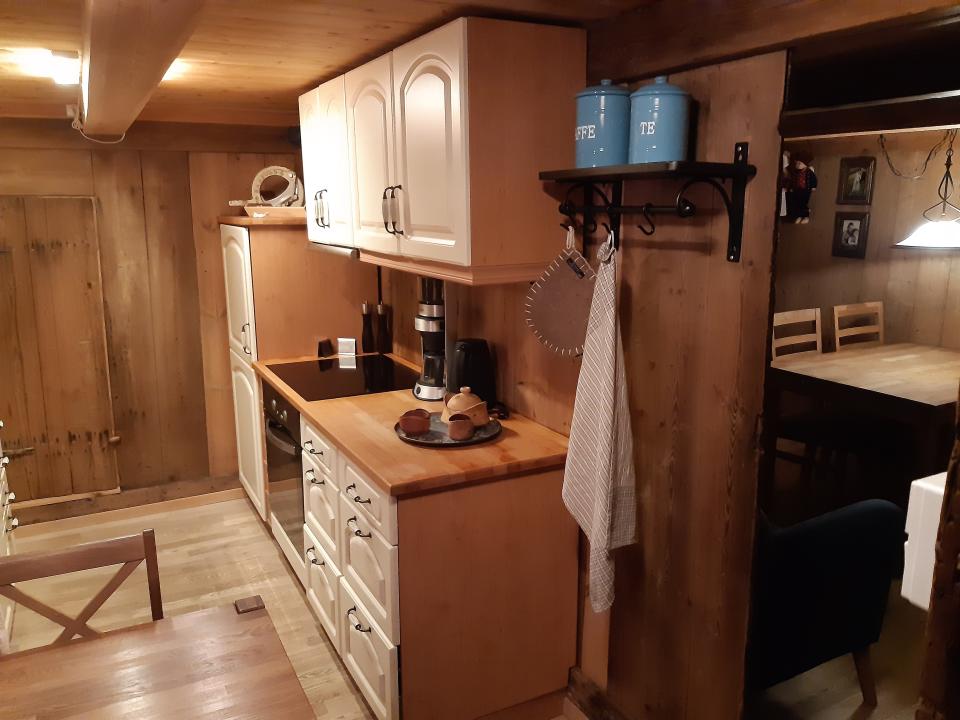 a small wood kitchen with white cabinets