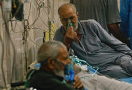 People with breathing problems are treated at a hospital during a sandstorm in Baghdad, Iraq, Monday, May 16, 2022. (AP Photo/Hadi Mizban)