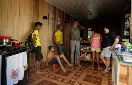 Raimundo Mendes de Barros, 71, who has worked as a rubber extractor for 57 years, talks with his wife and children at his house in Chico Mendes Extraction Reserve in Xapuri, Acre state, Brazil, June 22, 2016. REUTERS/Ricardo Moraes