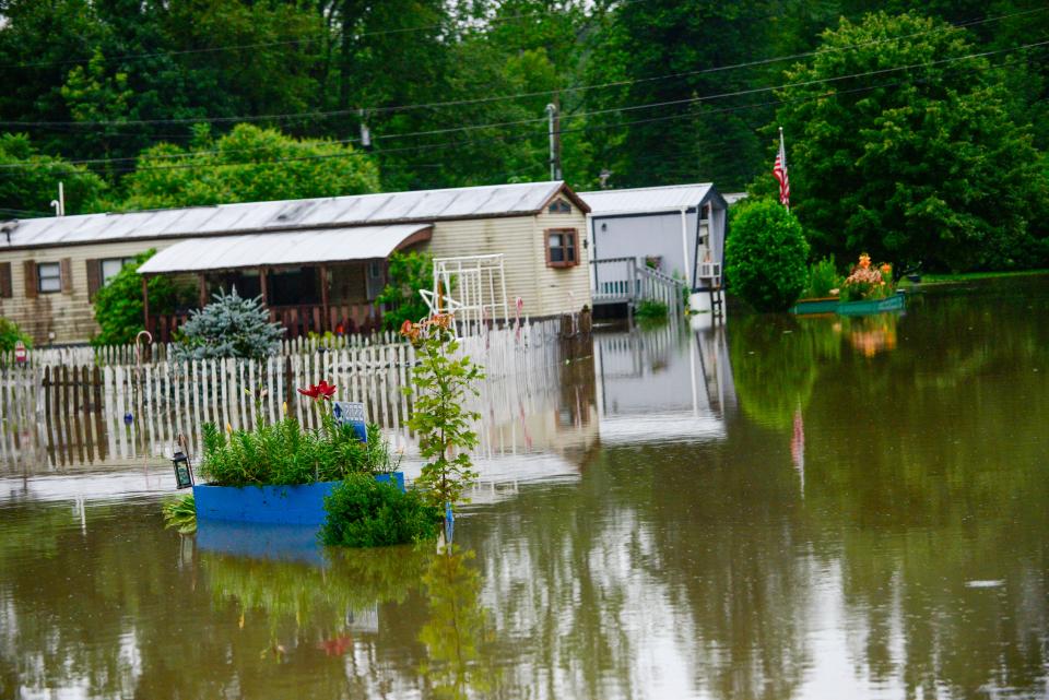 Trailers are evacuated at the Tri-Park Co-Op Housing in Brattleboro, Vt., as the water in the Whetstone Brook crests, Monday, July 10, 2023. (Kristopher Radder/The Brattleboro Reformer via AP)