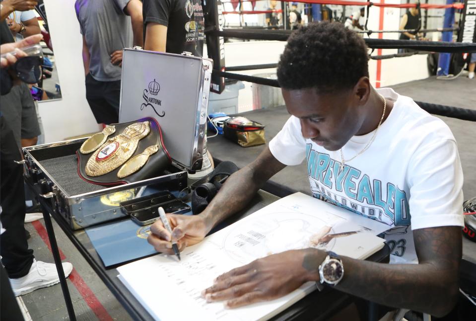 Dominique Crowder signs autographs during a ceremony at APJ Boxing in Poughkeepsie Aug. 23, 2023. Crowder won the WBA bantamweight international title earlier this month and he was celebrated in a ceremony by the gym that first trained him.