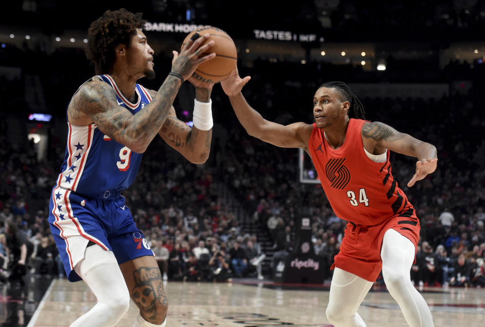 CORRECTS TO 2024 NOT 2023 - Philadelphia 76ers guard Kelly Oubre Jr. left, looks to get past Portland Trail Blazers forward Jabari Walker, right, during the first half of an NBA basketball game in Portland, Ore., Monday, Jan. 29, 2024. (AP Photo/Steve Dykes)