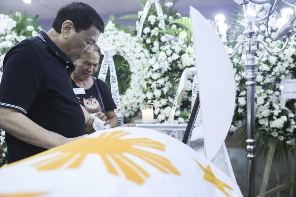 In this photo provided by the Presidential Malacanang Palace on Saturday July 20, 2019, Philippine President Rodrigo Duterte visits the wake for slain police officers at Camp Lt. Col. Francisco C. Fernandez Jr. in Sibulan, Negros Oriental, in Central Philippines. On Thursday, July 25, 2019, President Rodrigo Duterte said he raised a reward of 3 million pesos ($59,000) out of anger for what he described as the Islamic State group-style killings of the officers on July 18 in Negros Oriental province. Communist guerrillas claimed responsibility for the attack but denied torturing the police officers. (Ace Morandante/Presidential Photo Via AP)