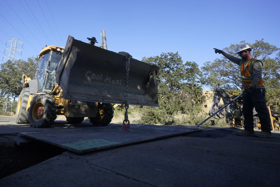 A Pacific Gas and Electric crew works on burying power lines in Vacaville, Calif., Wednesday, Oct. 11, 2023. PG&E wants to bury many of its power lines in areas threatened by wildfires. (AP Photo/Jeff Chiu)