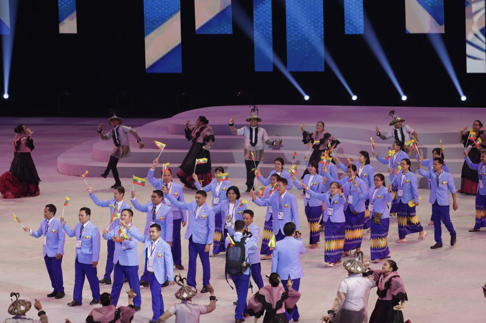 Myanmar's athletes hold flags during the opening ceremony of the 30th South East Asian Games at the Philippine Arena, Bulacan province, northern Philippines on Saturday, Nov. 30, 2019. (AP Photo/Aaron Favila)