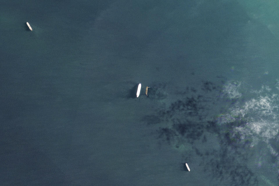 In this satellite photo by Planet Labs PBC, the oil tankers the Oceania, center left, and the Abyss, center right, are seen in the Malacca Strait between Indonesia and Malaysia on Tuesday, March 28, 2023. The Oceania, owned by a major U.S.-traded transportation company, appears to be taking on Iranian crude oil in a key Asian maritime strait in violation of American sanctions, an advocacy group alleges. The firm allegedly involved, Euronav, said Wednesday, March 29, 2023, it will "take appropriate action when necessary." (Planet Labs PBC via AP)