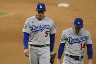 Los Angeles Dodgers shortstop Corey Seager (5) and Enrique Hernandez walk off the field after Game 4 of the baseball World Series Saturday, Oct. 24, 2020, in Arlington, Texas. Rays defeated the Dodgers 8-7 to tie the series 2-2 games. (AP Photo/Eric Gay)