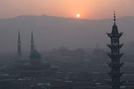 The sun rises over mountains and mosques in China's Linxia, Gansu province, home to a large population of ethnic minority Hui Muslims, February 3, 2018. Picture taken February 3, 2018. REUTERS/Michael Martina