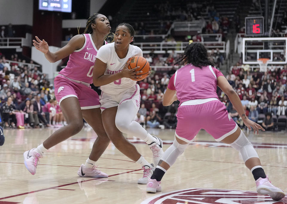 Stanford forward Nunu Agara, center, drives to the basket against California's Ugonne Onyiah (0) and Leilani McIntosh (1) during the second half of an NCAA college basketball game Friday, Feb. 16, 2024, in Stanford, Calif. Stanford won 84-49. (AP Photo/Tony Avelar)