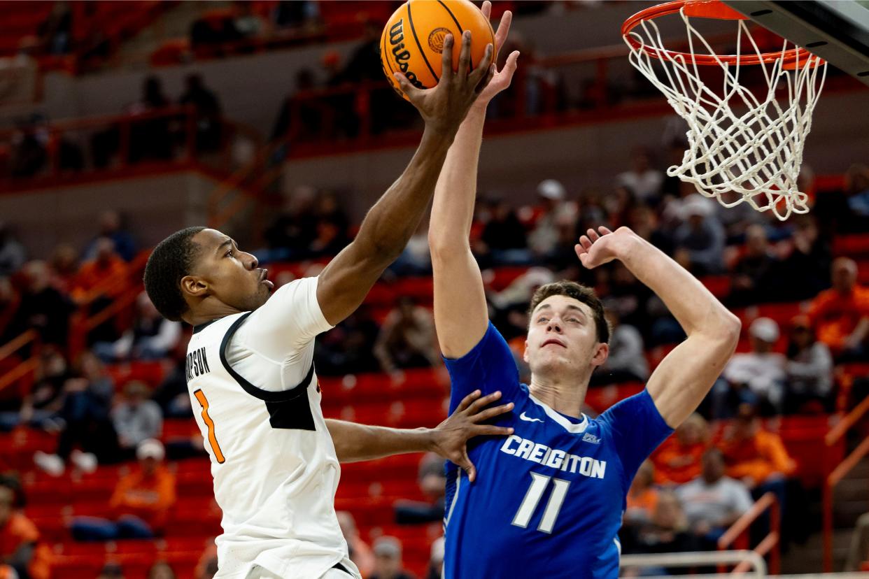 Oklahoma State guard Bryce Thompson (1) shoots a layup over Creighton center Ryan Kalkbrenner (11) in the second half of an NCAA college basketball game, Thursday, Nov. 30, 2023, in Stillwater, Okla. (AP Photo/Mitch Alcala)