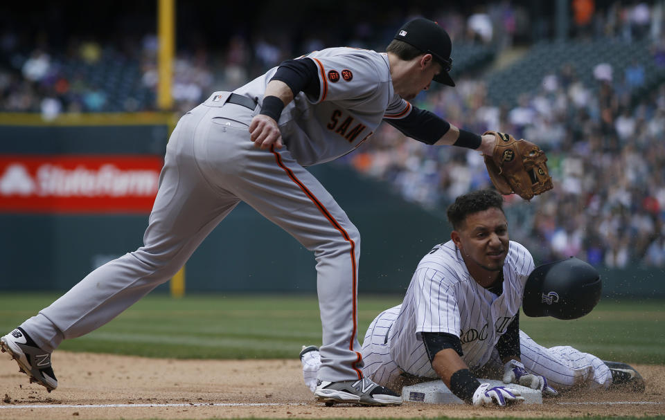 <p>San Francisco Giants third baseman Matt Duffy, left, fields the throw as Colorado Rockies’ Cristhian Adames slides safely into third base with a triple in the fifth inning of a baseball game Saturday, May 28, 2016, in Denver. (AP Photo/David Zalubowski) </p>