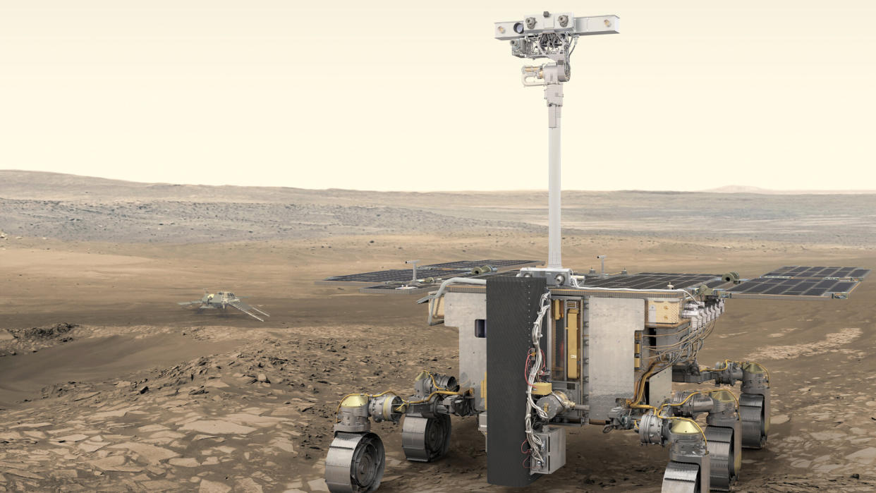  Illustration of a long-necked, six-wheeled rover on the surface of mars. 