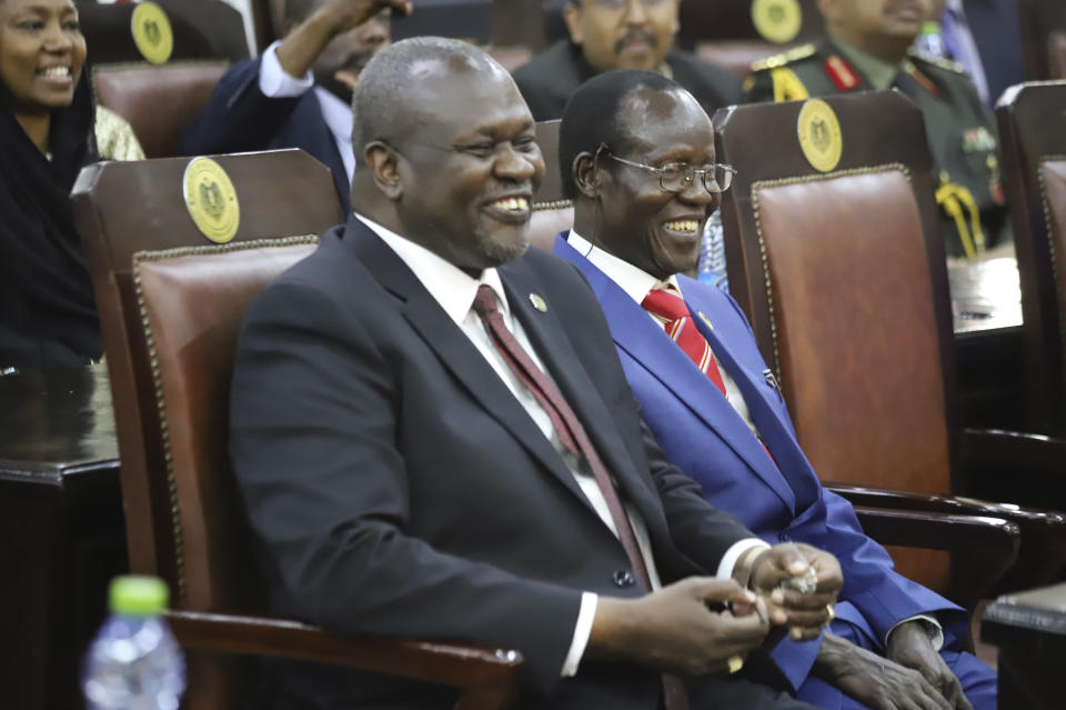 Dr. Riek Machar, left, after swearing in ceremony in Juba, South Sudan Saturday, Feb. 22, 2020. South Sudan opened a new chapter in its fragile emergence from civil war Saturday as rival leaders formed a coalition government that many observers prayed would last this time around. (AP Photo)