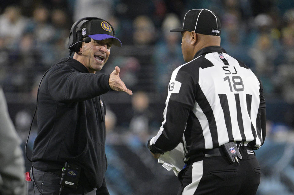 Baltimore Ravens head coach John Harbaugh argues a call with side judge Clay Reynard (18) in the first half of an NFL football game between the Ravens and the Jacksonville Jaguars Sunday, Dec. 17, 2023, in Jacksonville, Fla. (AP Photo/Phelan M. Ebenhack)