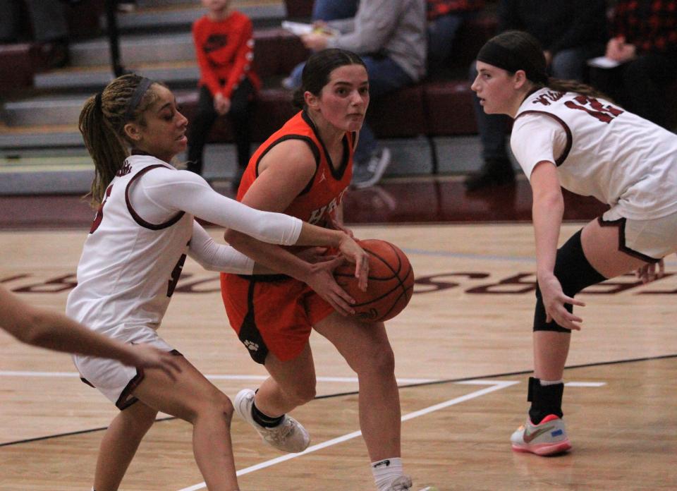 Heath's Caroline Robertson drives against Newark's Cadi Gordon, left, on Tuesday.