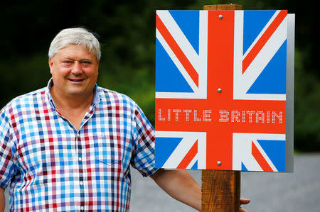 Gary Blackburn, a 53-year-old tree surgeon and collector of British curiosities from Lincolnshire, Britain, poses in front of a self-made "Little Britain" sign in Linz-Kretzhaus, south of Germany's former capital Bonn, Germany, August 24, 2017. Picture taken August 24, 2017 REUTERS/Wolfgang Rattay