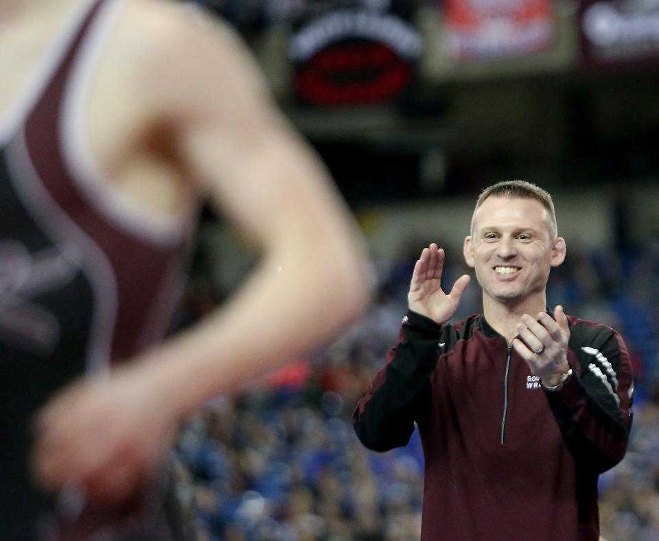 South Kitsap coach Chad Nass applauds Xavier Eaglin's win over Mead's Chase Randall during the Mat Classic Championships at the Tacoma Dome on Saturday, Feb. 17, 2018.