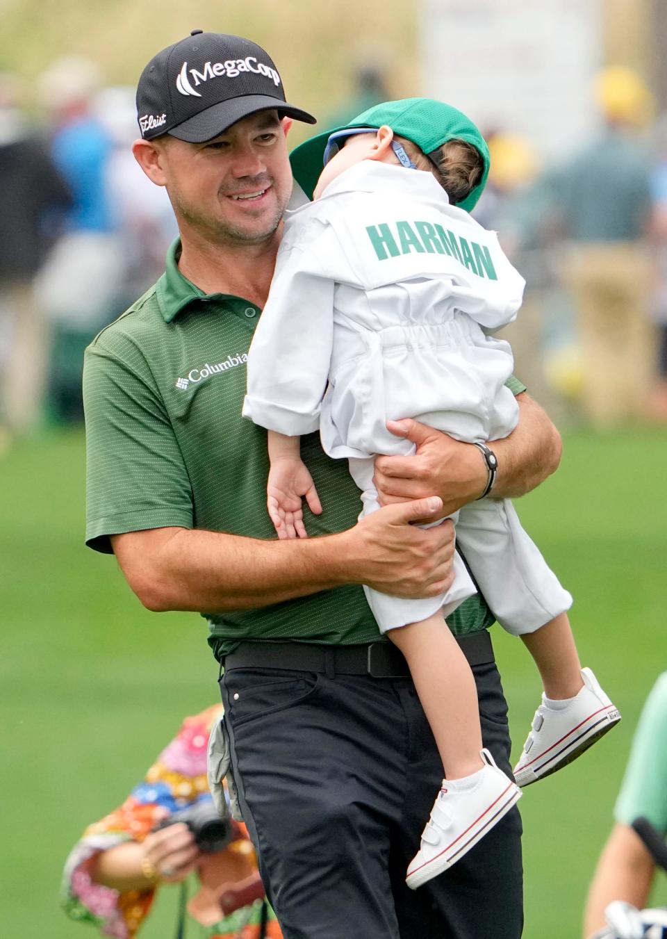 Brian Harman of St. Simons Island, Ga., carries his son Walter during the 2022 Par 3 Contest at Augusta National.