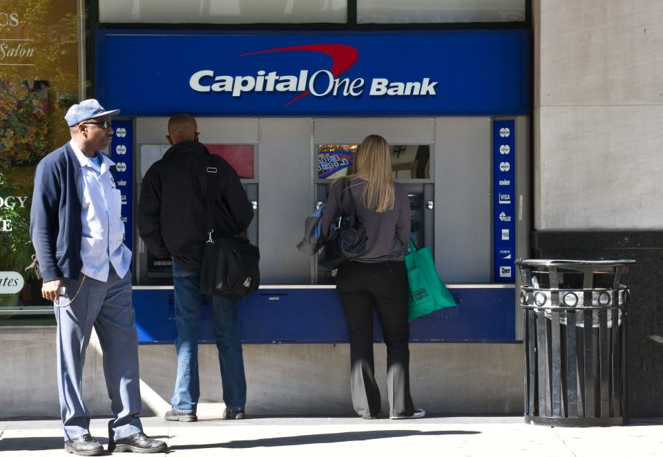 People use an ATM at a Capital One Bank branch in Washington on April 13, 2012.   AFP PHOTO/Nicholas KAMM (Photo by Nicholas KAMM / AFP) (Photo by NICHOLAS KAMM/AFP via Getty Images)