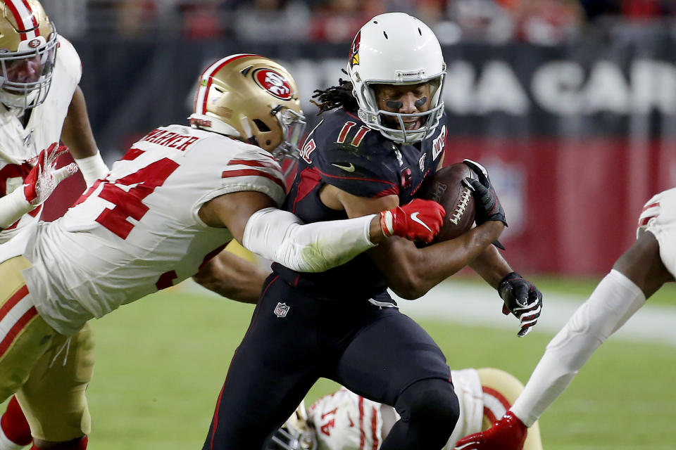 Arizona Cardinals wide receiver Larry Fitzgerald (11) is hit by San Francisco 49ers middle linebacker Fred Warner (54) during the second half of an NFL football game, Thursday, Oct. 31, 2019, in Glendale, Ariz. (AP Photo/Rick Scuteri)