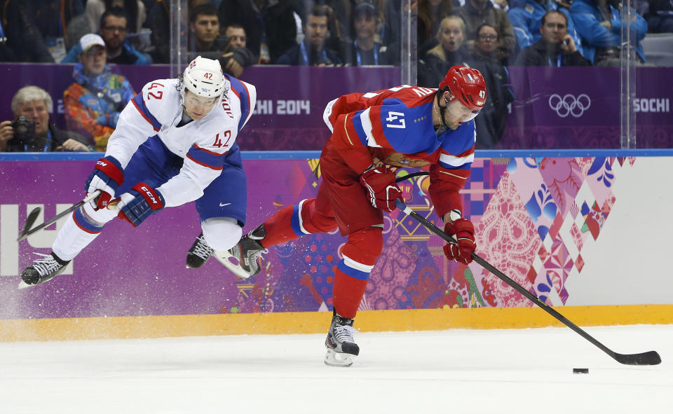 Norway defenseman Henrik Odegaard defends as Russia forward Alexander Radulov takes an off balance shot in the second period of a men's ice hockey game at the 2014 Winter Olympics, Tuesday, Feb. 18, 2014, in Sochi, Russia. (AP Photo/Mark Humphrey)