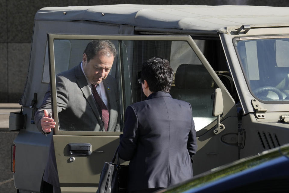 Sergiy Korsunsky, Ambassador of Ukraine to Japan, checks the Japan Ground Self-Defense Force's 1/2-ton truck, as it's a part of handover defense equipment, during the handover ceremony of defense equipment for Ukraine at the Ministry of Defense Wednesday, May 24, 2023, in Tokyo. (AP Photo/Eugene Hoshiko)