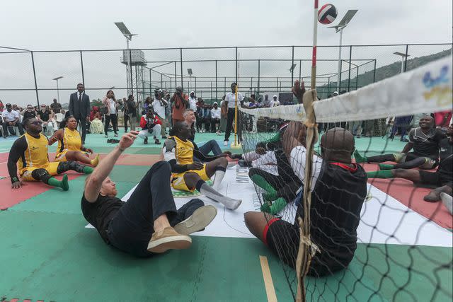 <p>KOLA SULAIMON/AFP via Getty</p> Prince Harry takes part in a sitting volleyball match at Nigeria Unconquered, a local charity organisation that supports wounded, injured, or sick service members, in Abuja on May 11, 2024