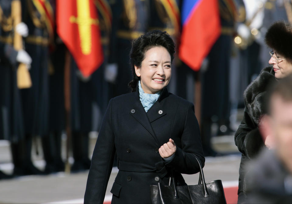 FILE - In this March 22, 2013 file photo, Chinese President Xi Jinping's wife Peng Liyuan smiles after arriving at the government airport Vnukovo II, outside Moscow, Russia. New Chinese first lady Peng is emerging as Chinese diplomacy's latest star. A well-known performer on state television, the glamorous Peng was featured prominently on Sunday's state media coverage of President Xi Jinping's activities in Russia. The visit is Xi's first since assuming the presidency earlier this month. (AP Photo/Ivan Sekretarev, File)