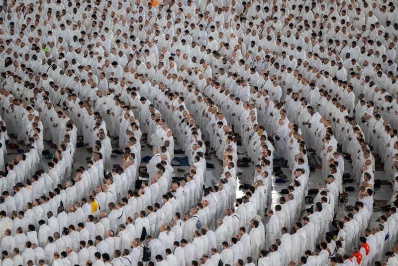 Muslim pilgrims pray in front of the al-Ka'bah as the annual Hajj pilgrimage season begins.  -/Saudi Press Agency/dpa