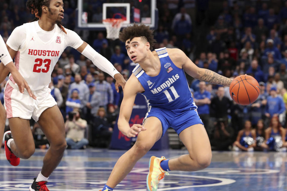 Memphis guard Lester Quinones (11) looks to shoot as Houston Cedrick Alley Jr. (23) moves in, in the second half of an NCAA college basketball game Saturday, Feb. 22, 2020, in Memphis, Tenn. (AP Photo/Karen Pulfer Focht)